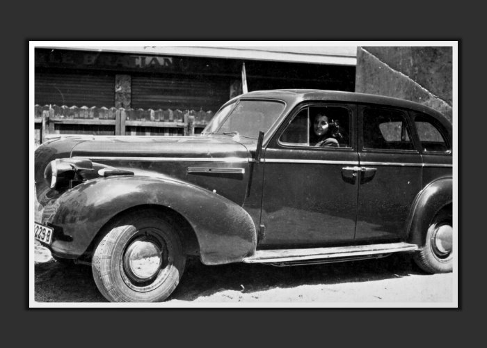 Cornell's mother, Mary, seated in the 1939 Buick in the  rear yard of the Concordia-Vega Refinery Headquarters in Bucharest.